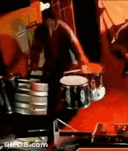 Man Playing Drums On Red Background GIF