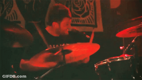 Man Playing Drums With Decals Shirt GIF