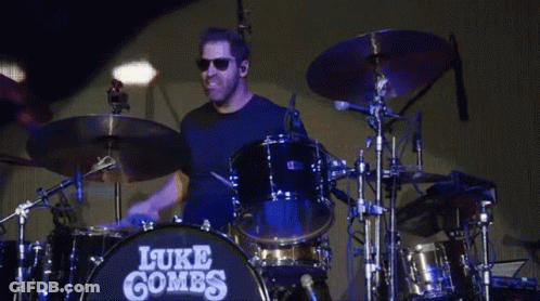Man Playing Drums With Name Luke Combs GIF