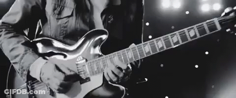 Man Playing Electric Guitar On Stage Black And White GIF