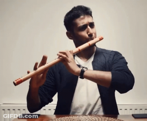 Man Playing Flute By Radiator Wearing Watch GIF