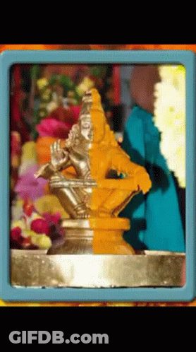 Man Playing Flute Statue With Flowers GIF