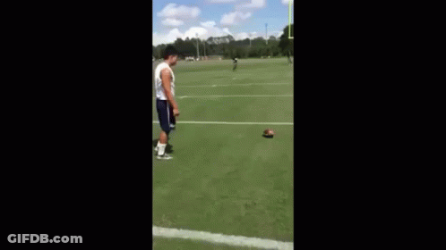 Man Playing Football On Field With Goal Post GIF