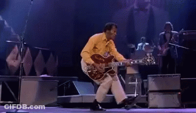 Man Playing Guitar And Dancing On Stage GIF