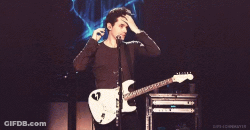 Man Playing Guitar And Singing Into Microphone GIF
