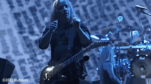 Man Playing Guitar And Singing Into Microphone With Drummer GIF
