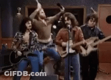 Man Playing Guitar And Singing Into Microphone With Drummer GIF