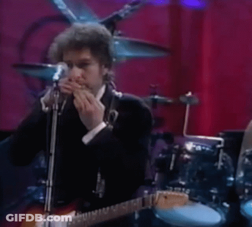 Man Playing Guitar And Singing Into Microphone With Harmonica GIF