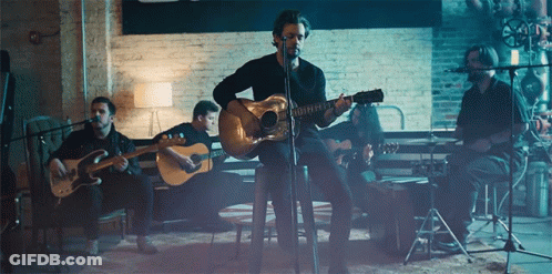 Man Playing Guitar At Microphone GIF