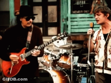 Man Playing Guitar Beside Singing Man GIF