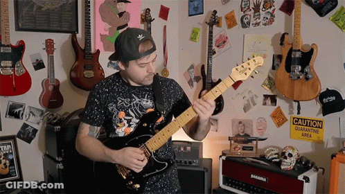 Man Playing Guitar By Caution Sign GIF