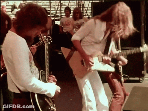 Man Playing Guitar For Crowd In BB Shirt GIF