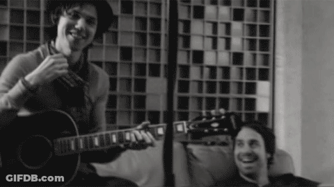 Man Playing Guitar In Black And White Photo GIF