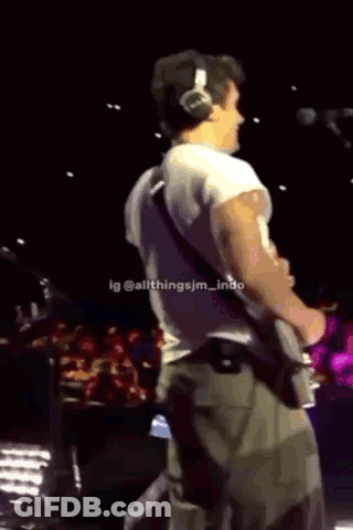 Man Playing Guitar In Black Camp Lion Shirt GIF