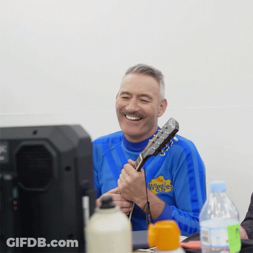 Man Playing Guitar In Blue Wiggles Shirt GIF