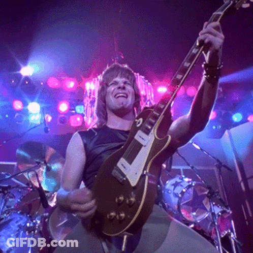 Man Playing Guitar In Dark Room With Purple Lights GIF