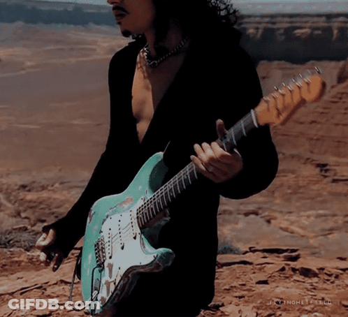 Man Playing Guitar In Desert With Text Jaynghetfield GIF