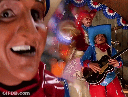Man Playing Guitar In Front Of Buck Sign GIF