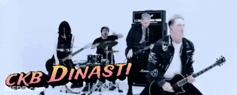 Man Playing Guitar In Front Of CKB Dinasti Sign GIF