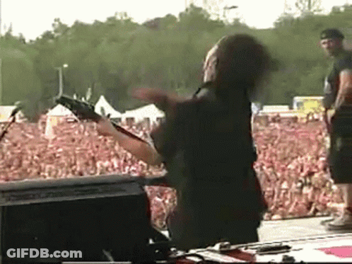 Man Playing Guitar In Front Of Crowd GIF