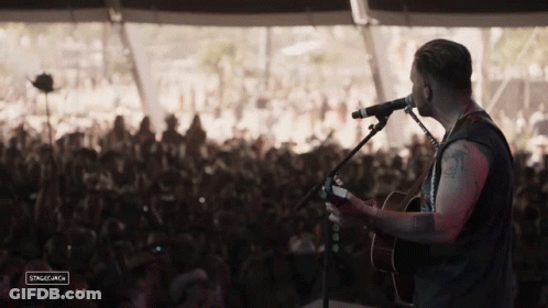 Man Playing Guitar In Front Of Crowd GIF