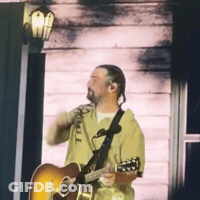 Man Playing Guitar In Front Of Door GIF