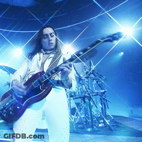Man Playing Guitar In Front Of Drum Set GIF