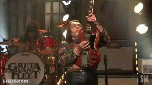 Man Playing Guitar In Front Of Greta Van Fleet GIF