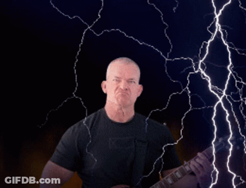 Man Playing Guitar In Front Of Lightning Strike GIF