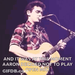 Man Playing Guitar In Front Of Microphone GIF