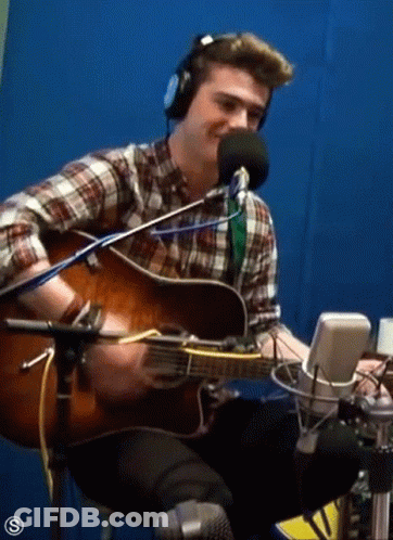 Man Playing Guitar In Front Of Microphone GIF