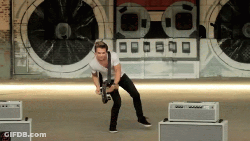 Man Playing Guitar In Front Of O Wall GIF
