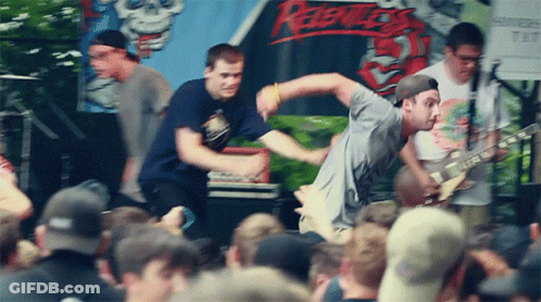 Man Playing Guitar In Front Of Rebels Sign GIF