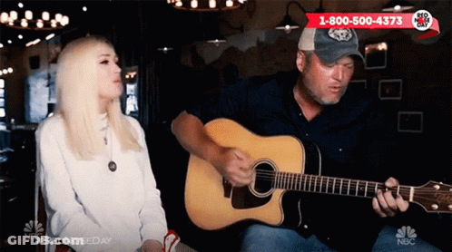 Man Playing Guitar In Front Of Sitting Woman GIF
