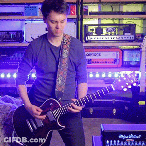 Man Playing Guitar In Front Of Stack Of Orange Amps GIF
