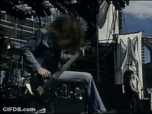 Man Playing Guitar In Front Of X Sign GIF