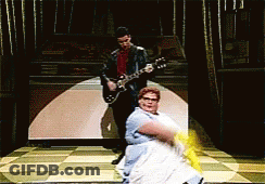 Man Playing Guitar Next To Dancing Woman GIF
