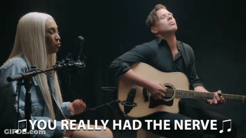 Man Playing Guitar Next To Woman Singing Nerve GIF