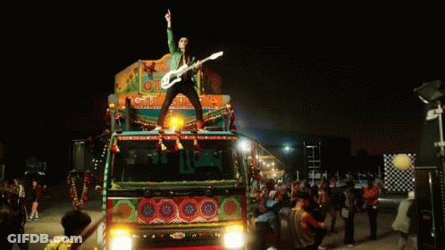 Man Playing Guitar On Cit Truck GIF
