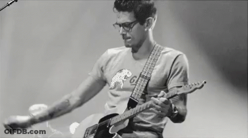 Man Playing Guitar On Stage Black And White GIF