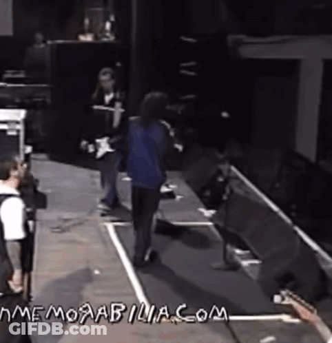 Man Playing Guitar On Stage With Memorabilia.com GIF