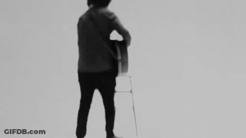 Man Playing Guitar On Stool Black And White GIF