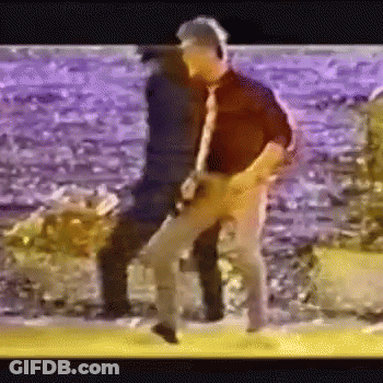 Man Playing Guitar While Another Dances GIF