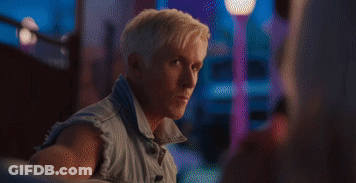 Man Playing Guitar While Woman Sits On Couch In Front Of Fireplace GIF