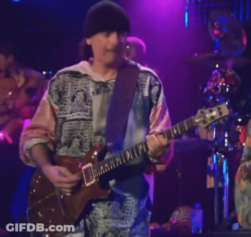 Man Playing Guitar With Band Saying Santana GIF