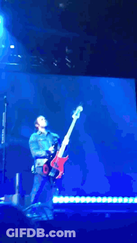 Man Playing Guitar With Flames On Stage GIF