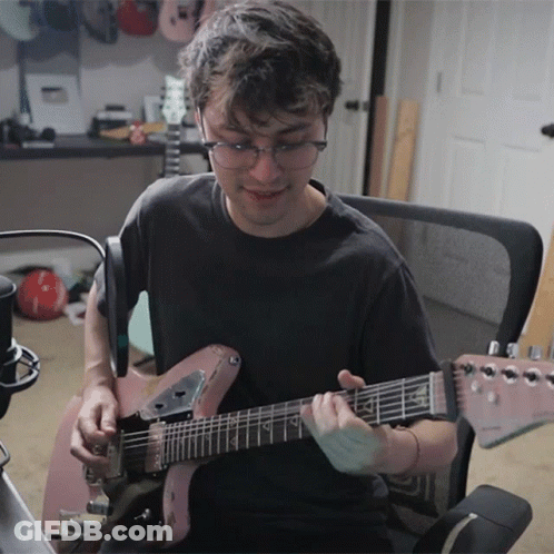 Man Playing Guitar With Letter A On Neck GIF