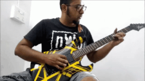 Man Playing Guitar With Shirt Saying NY GIF