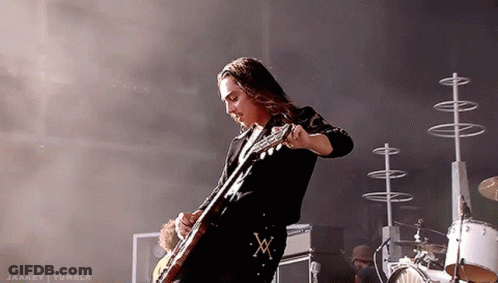 Man Playing Guitar With X On Belt GIF