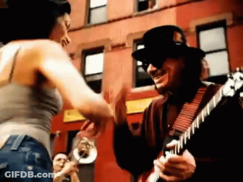 Man Playing Guitar Woman Dancing Outside Building GIF